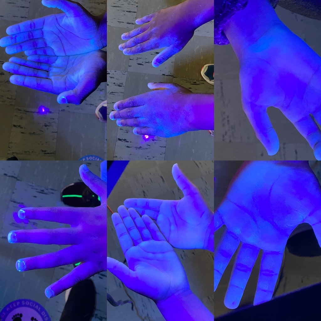 Image of germs glowing on hands